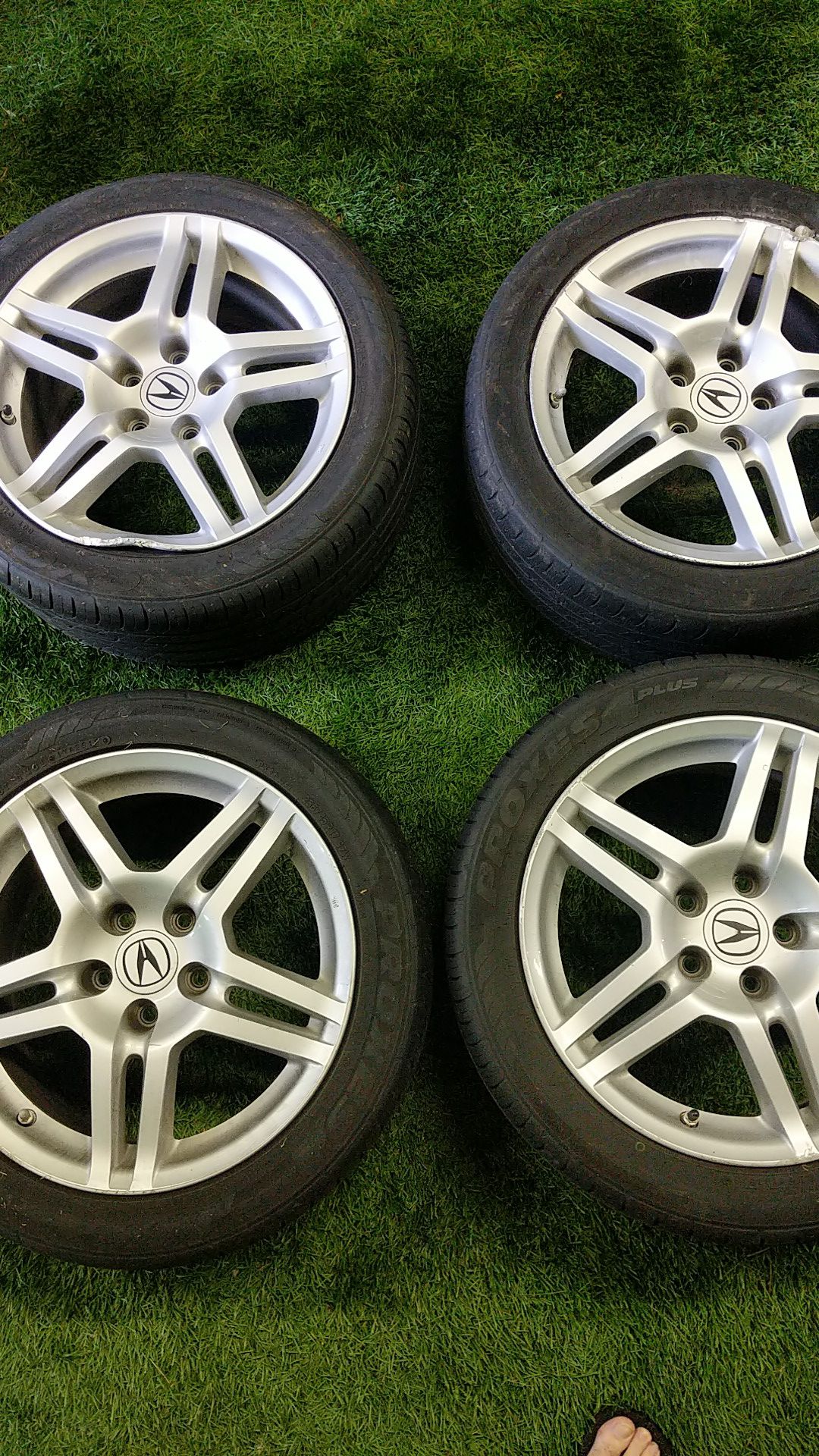 Acura rims and tires (4) . 2 tires and rims damaged by curb. 2 in great condition