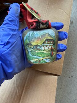 Vintage metal cowbell has a hand-painted alpine landscape
