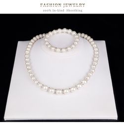Set of imitation pearls contains (earrings, necklace and bracelet)