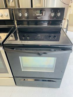 Black Whirlpool stove; a receipt covering a 60-day warranty.