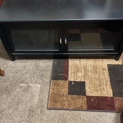 Black Tv Stand With Glass Doors! It Has Been Wrapped In Plastic In Storage Never Used!! 