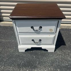 White 2 drawer nightstand with brown wood top 24”T 23”L 17”W