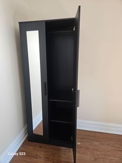 Black wardrobe with mirrors on door