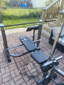 Weight bench/squat rack 300lbs Olympic plates barbell & weight tree & lat pull-down