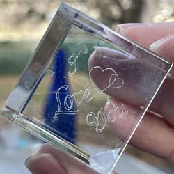 Small glass square with the saying I love you inside.