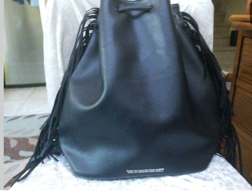 Victoria secret backpack bag with tags on it. Also has black fringe on sides