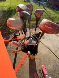 Older set of right handed golf clubs and bag