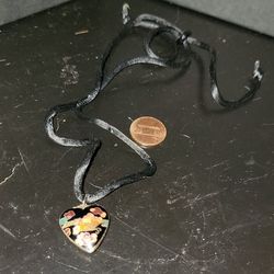 Metal black heart on black string