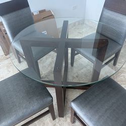 Glass dining table with four chairs