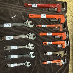 All sizes of pipe wrenches and crescent wrenches