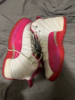 Pink and white Jordan 12s