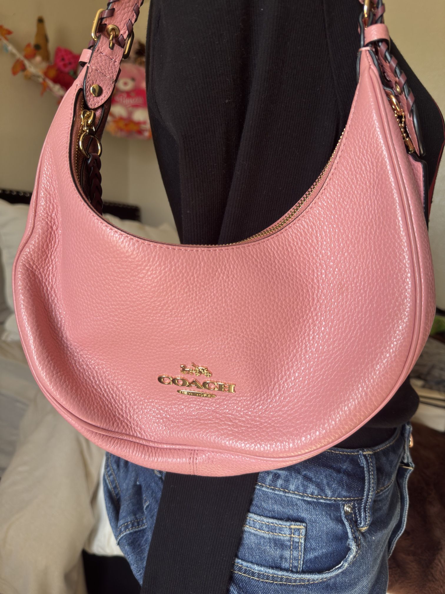 Peach Coach bag with purple and gold details 
