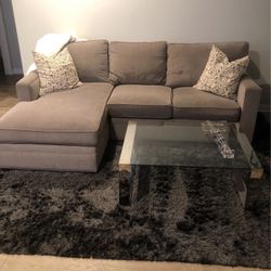 Couch, black shag rug, and glass chrome coffee table 
