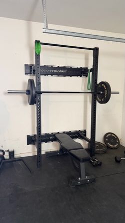 Wall-Mounted Folding Power Rack + weights and adjustable bench