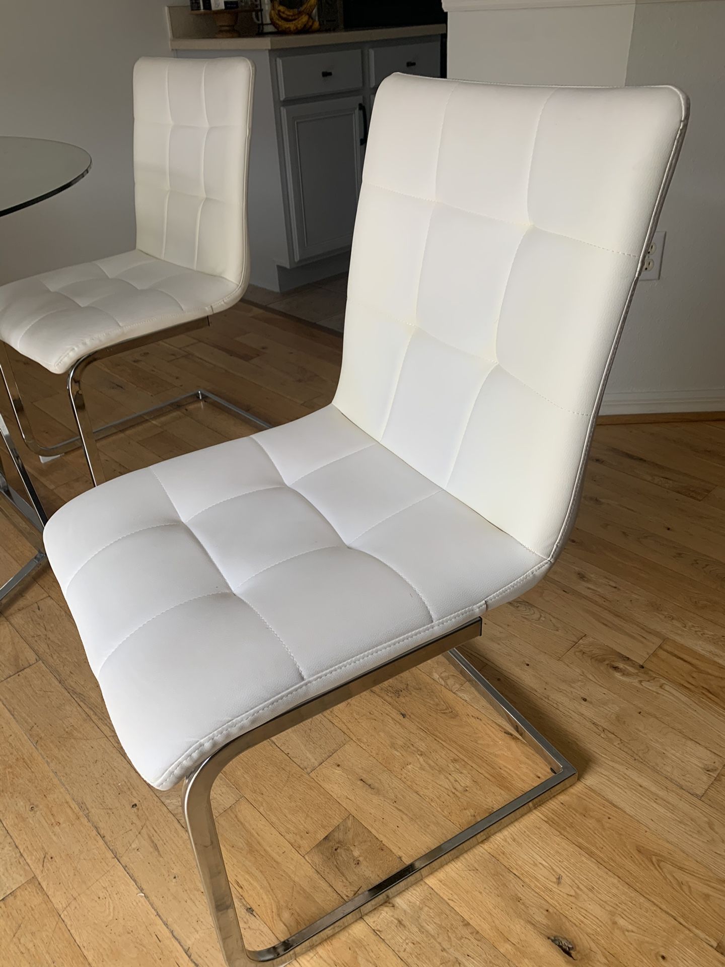 4 White Leather dining room chairs in great condition