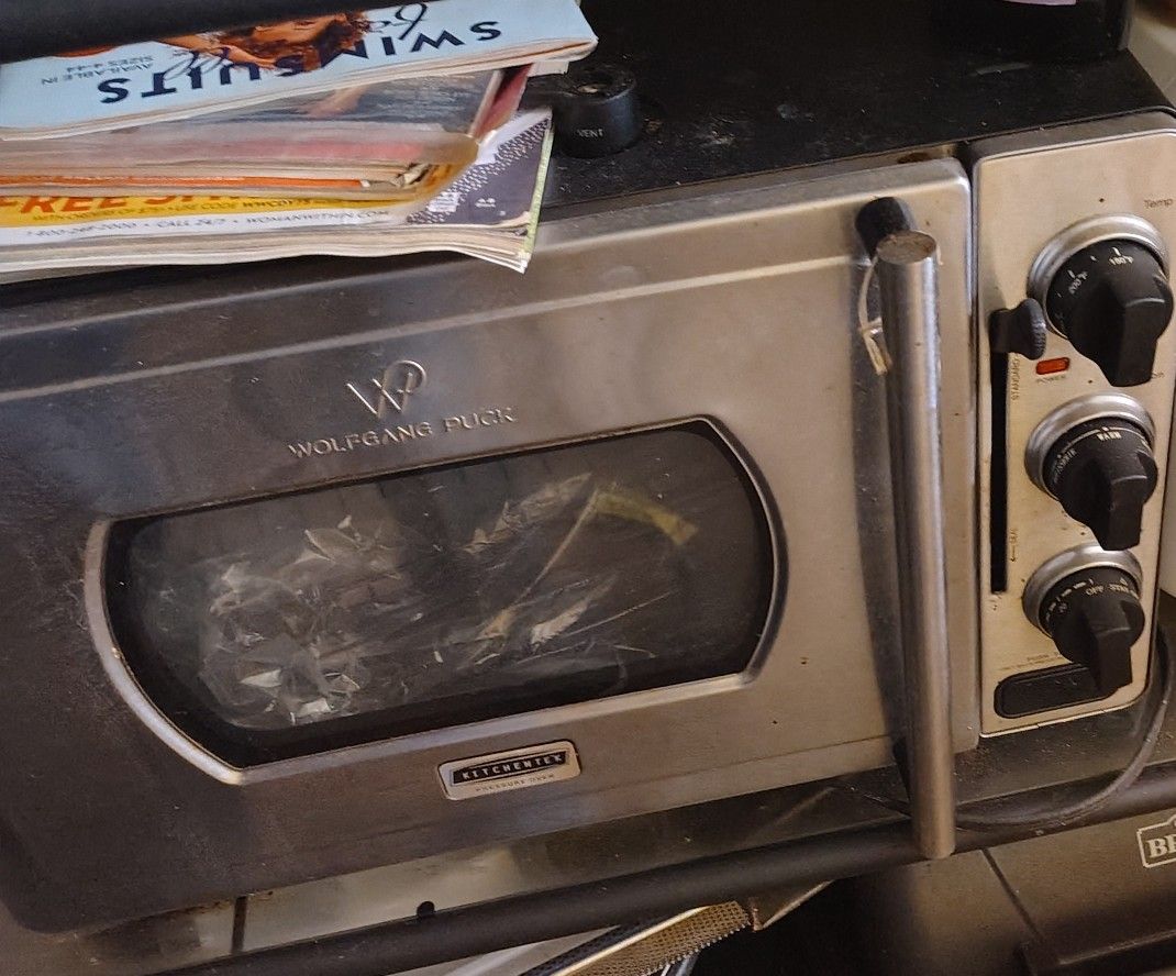 The image displays a Wolfgang Puck KitchenTek Pressure Oven, a countertop appliance that combines conventional oven functions with pressure cooking te