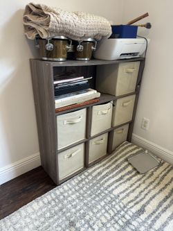 Two Bookshelves With Baskets
