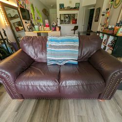 USED-FAIR Dark Red Leather Love seat. Very Clean And Comfy 