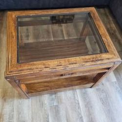 Glass top end table - brown wood