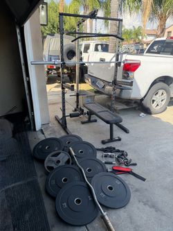 Bench press/squat rack with pulley system and 7ft bar plus 230lbs of Olympic weights and curl bar