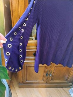 A  purple top with rhinestones on bell sleeves