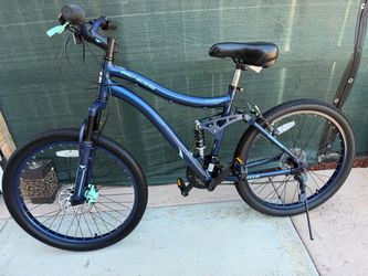 Genesis Bella Vista 24-inch full-suspension mountain bike in blue with contrasting teal accents.
