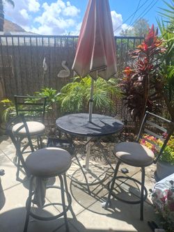 High bar chairs(3) and table for patio. Umbrella and the holder of umbrella .
