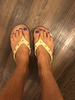 Tory Burch beige flip flops with gold emblems throughout. Woman’s size 9