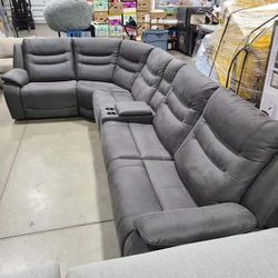 Kelsee Fabric Power Reclining Sectional with Power Headrests

Features:
Three Power Recliners with Power Headrests
Storage Console 