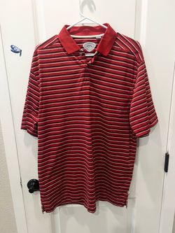 This is a red and white striped Callaway Golf shirt featuring the signature heat-seal logo label on the inner neckline.