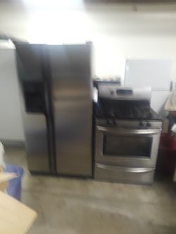 Stainless steel GE refrigerator in Frigidaire stove