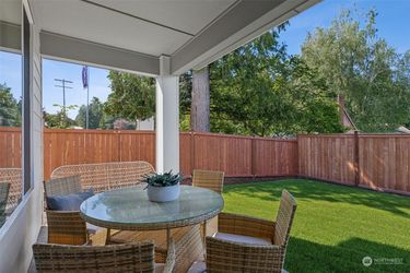 Outdoor patio furniture, one round table with glass top and 4 chairs with seat cushions