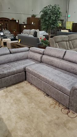 Sleeper sectional with storage ottoman