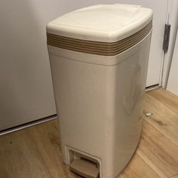 Brown, beige tan trash container can. Medium sized.