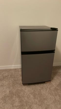 Silver and black mini fridge