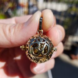 Om brass pendants and locket.