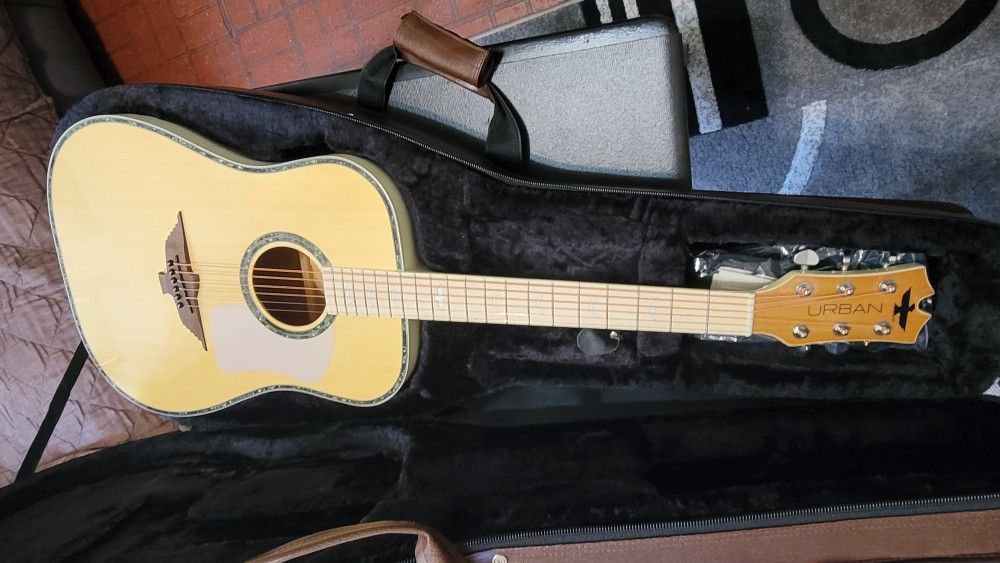 KEITH URBAN THE PHOENIX COLLECTION IMPORTED ACOUSTIC ELECTRIC GUITAR DREINAUGH IN YELLOW COLOR.