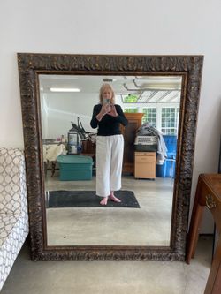 Large ornate bronze toned framed mirror