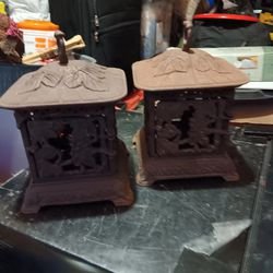 Two vintage  outdoor cast iron candle holders