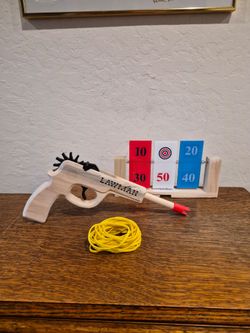 Magnum Enterprises Lawman Rubber Band Gun, a 12-shot semi-automatic wooden toy