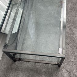 54" Clear Glass and Steel Coffee Table with Shelf
