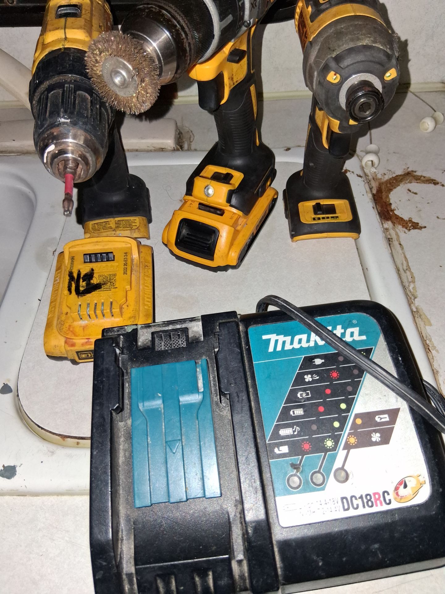 Bundle one cordless impact driver cordless drill driver and another cordless drill driver two batteries and a Makita charger