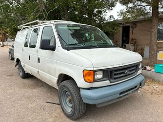 white Ford E-Series cargo van,