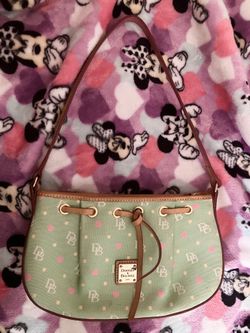 Dooney & Bourke light blue canvas small babydoll purse with a heart and DB logo print. 