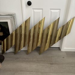 A metal "Torrent" wall sculpture by C. Jere (California), in the form a lightning bolt
