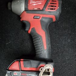 Milwaukee M18 1/4 inch hex impact driver and an M18 REDLITHIUM battery