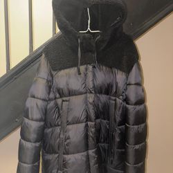 Koolaburra by UGG women's puffer jacket. It is often described as a "mixed-media" jacket because of the combination of the puffer material and a sherp