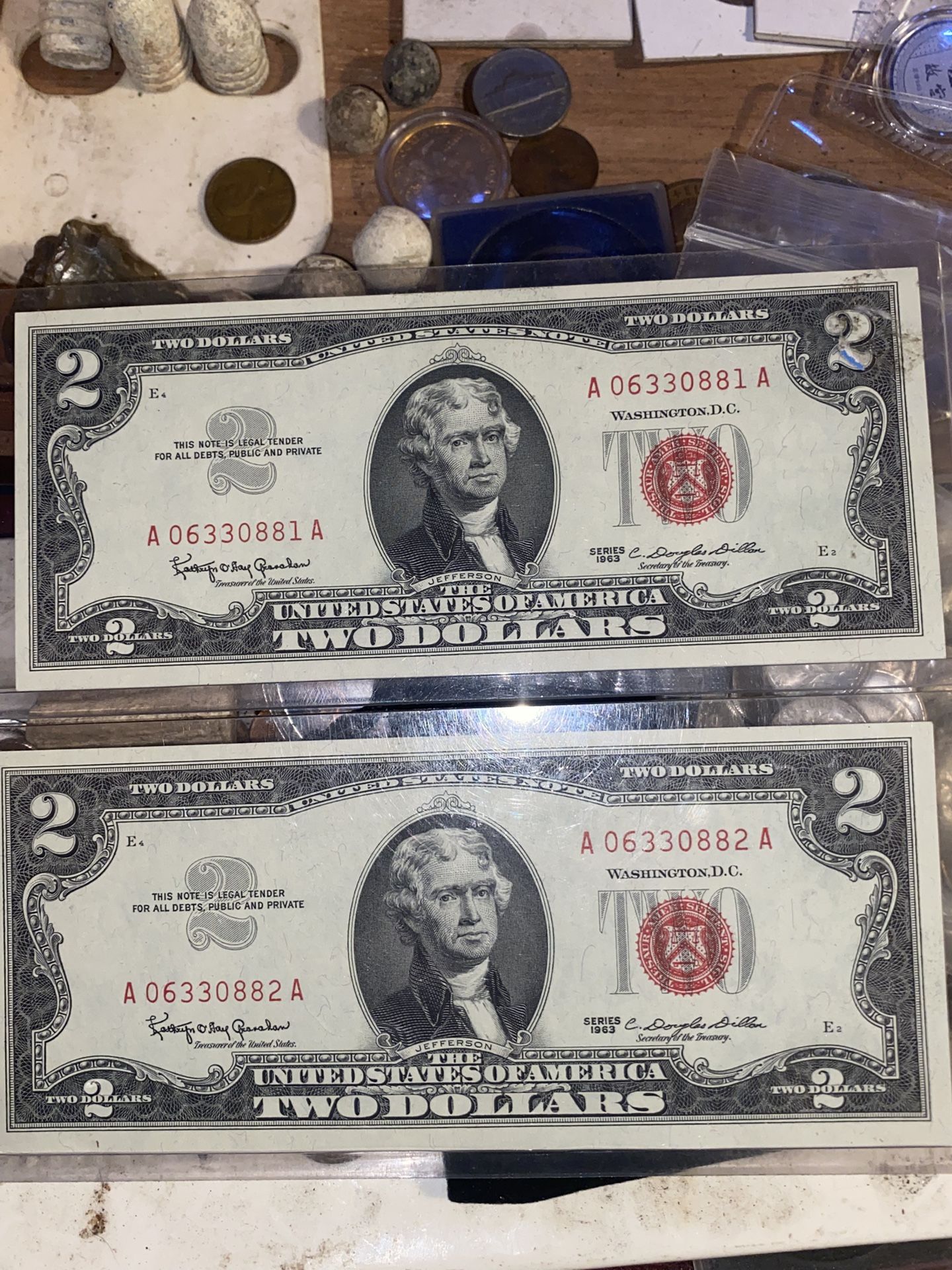 Two individual 2)$ bank bills from 1963 with the red seal erial nubers *NSYNC