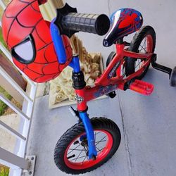 SPIDER MAN BIKE WITH TRAINING WHEELS  & THE HEAD LIGHTS UP  & STORAGE IN BACK OF HEAD/ REASONABLE OFFERS WELCOME