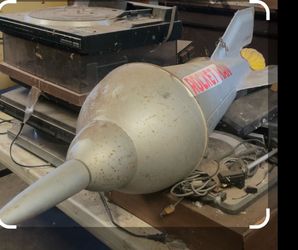 Vintage Metal Rocket man prop hangs from ceiling